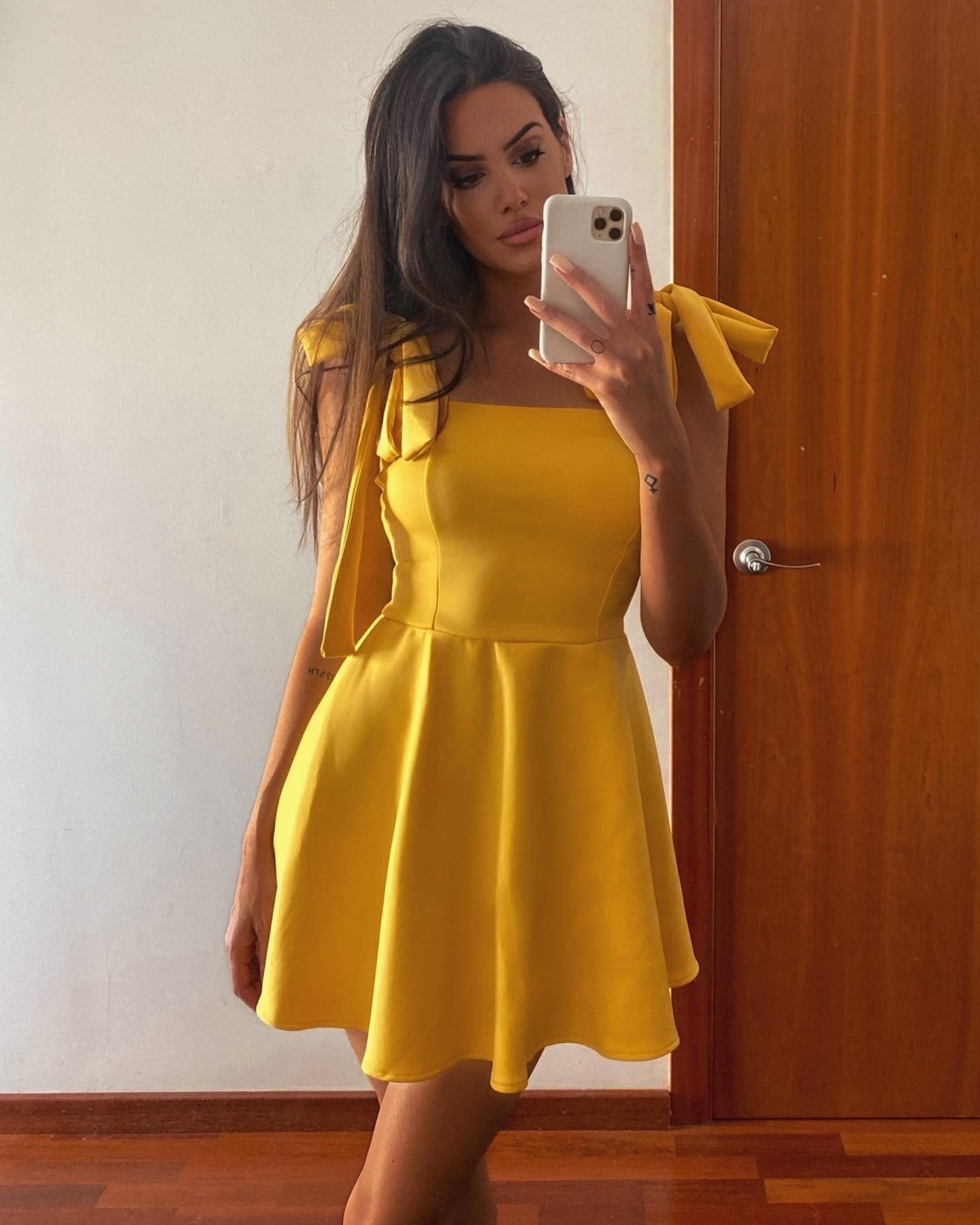 mini yellow dress with tie straps and a floaty skirt detail